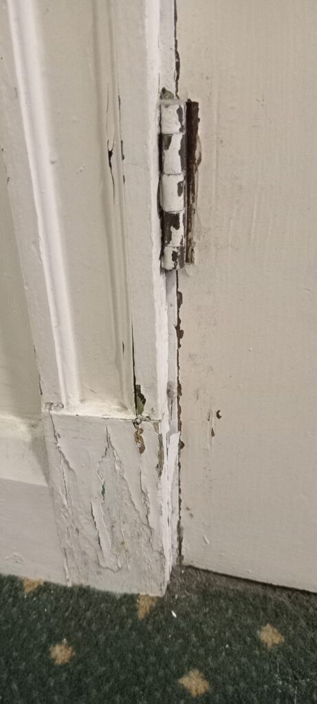 Filling, sanding and caulking a door frame as part of a full property redecoration project