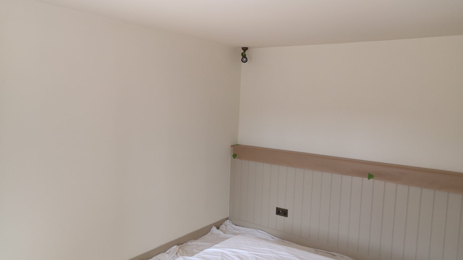 Rustic style panelling in a bedroom as part of a full redecoration project
