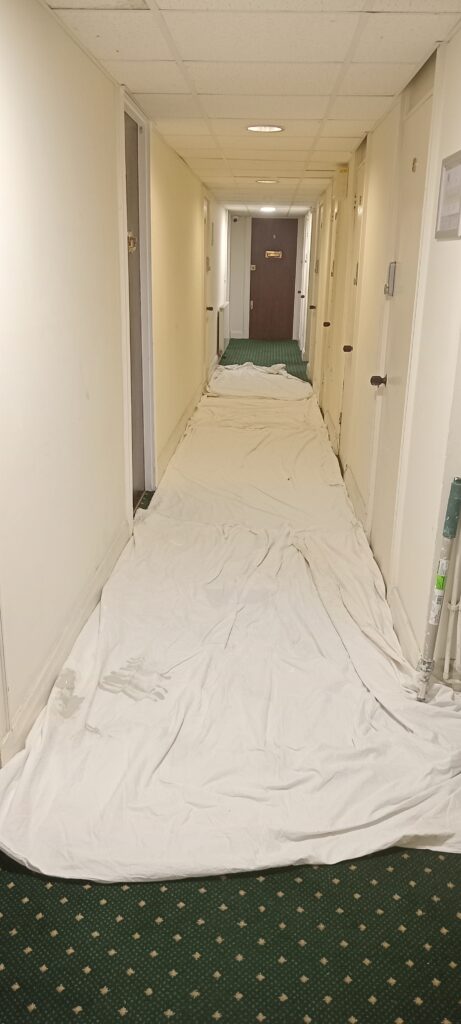 Repairing a communal corridor in London as part of a flat redecoration project