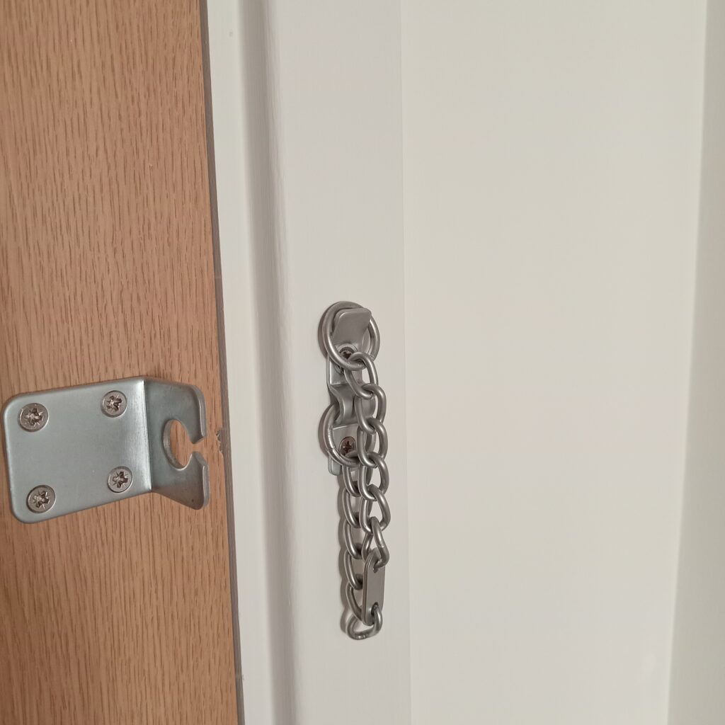 Door chain, removed, frame painted and door chain remounted.